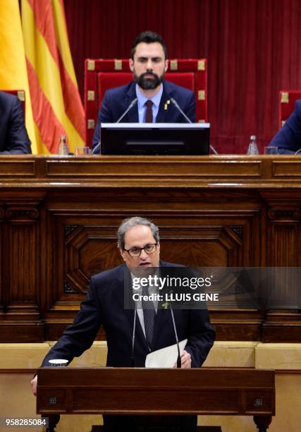 Catalan Parliament Speaker Roger Torrent listens to a speech by Junts per Catalonia MP and presidential candidate Quim Torra during a vote session to...