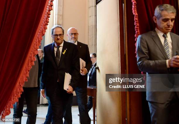 Junts per Catalonia MP and presidential candidate Quim Torra and Junts per Catalonia MP Eduard Pujol arrive to attend a vote session to elect a new...