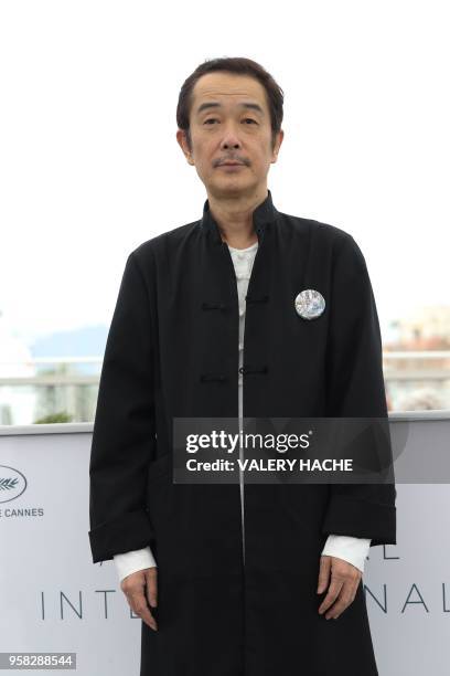 Japanese writer and actor Lily Franky poses on May 14, 2018 during a photocall for the film "Shoplifters " at the 71st edition of the Cannes Film...