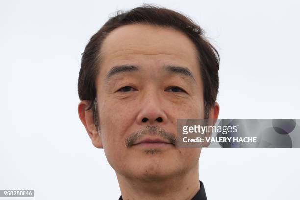 Japanese writer and actor Lily Franky poses on May 14, 2018 during a photocall for the film "Shoplifters " at the 71st edition of the Cannes Film...