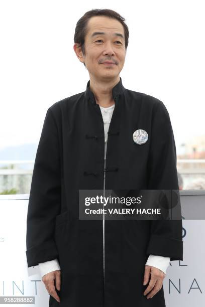 Japanese writer and actor Lily Franky poses on May 14, 2018 during a photocall for the film "Shoplifters " at the 71st edition of the Cannes Film...