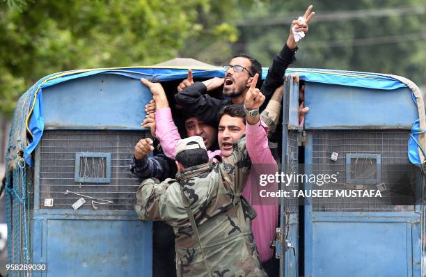 Kashmiri government teachers shout anti government slogans inside a police vehicle after been detained by Indian police during a protest against the...