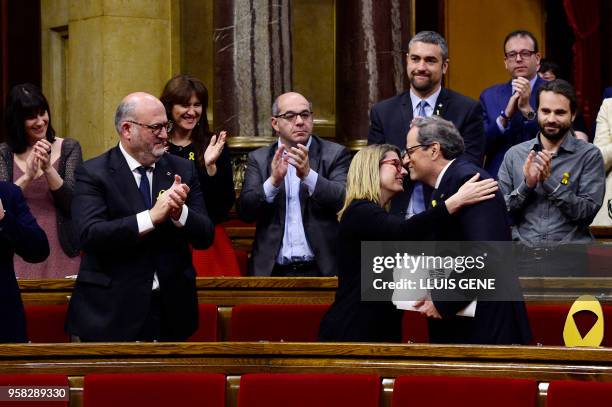 Junts per Catalonia MP and presidential candidate Quim Torra is kissed by Junts per Catalonia MP Elsa Artadi and applauded by his parliamentary group...