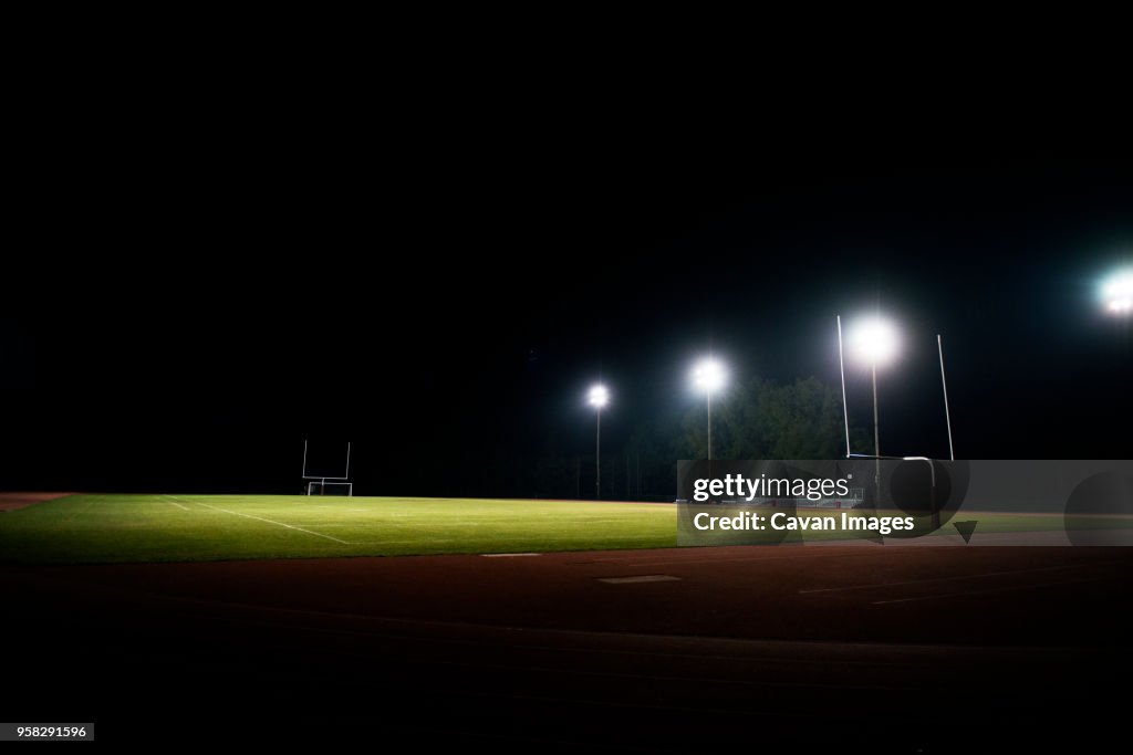 Scenic view of illuminated American football field at night