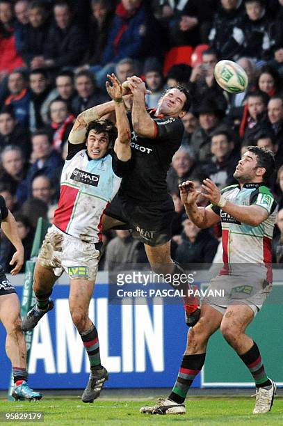 Toulouse's centre Florian Fritz collapses with London Harlequins' flanker Will Skinner and fly-half Nick Evans during their European Cup rugby union...