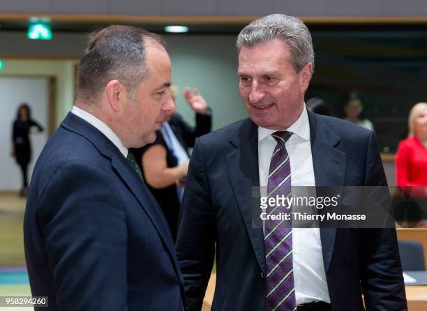 Polish European affairs minister Konrad Szymanski talks with the EU Budget & Human Resources Commissioner Guenther Oettinger prior a European General...