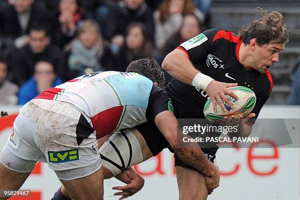 Toulouse's winger Cedric Heymans is tackled by London Harlequins number eight Nick Easter during their European Cup rugby union match on January 17,...