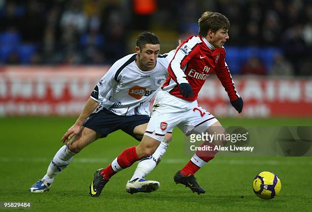 Andrey Arshavin of Arsenal is pressurised by Gary Cahill of Bolton Wanderers during the Barclays Premier League match between Bolton Wanderers and...