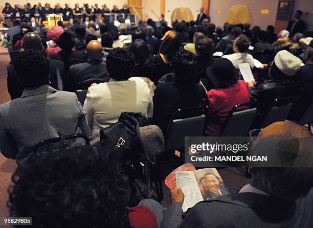 Church-goer looks at a program with a photo of Rev. Dr. Martin Luther King Jr. During Sunday church service at Vermont Avenue Baptist Churst January...