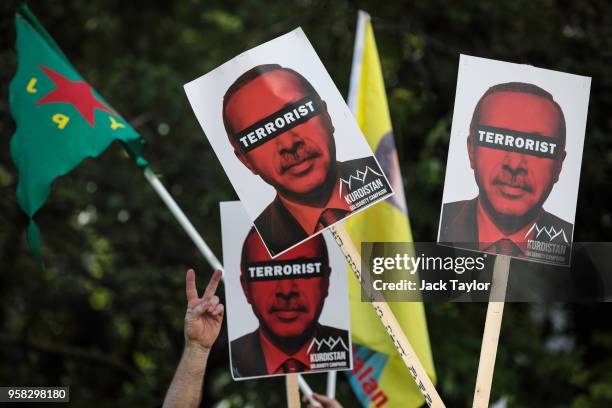 Anti-Erdogan protesters hold placards aloft as they demonstrate outside Chatham House where Turkish President Recep Tayyip Erdogan is due to speak on...