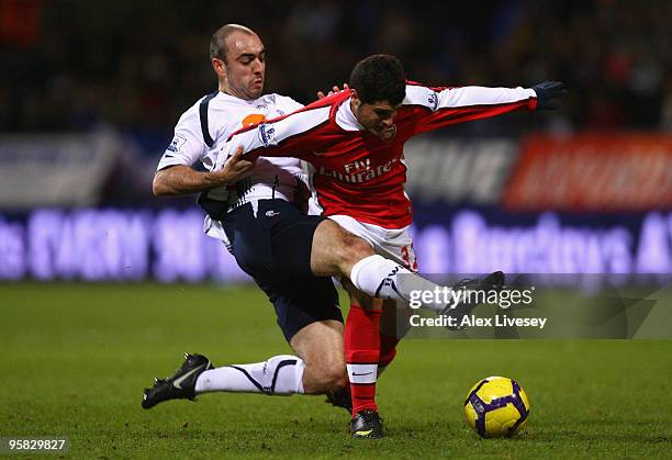 Gavin McCann of Bolton Wanderers challenges Fran Merida of Arsenal during the Barclays Premier League match between Bolton Wanderers and Arsenal at...