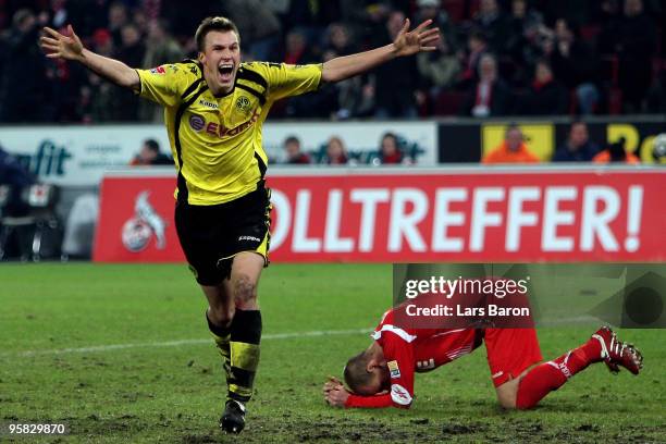 Kevin Grosskreutz of Dortmund celebrates after scoring the winning goal next to Kevin McKenna of Koeln during the Bundesliga match between 1. FC...