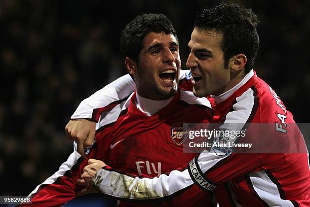 Fran Merida of Arsenal celebrates scoring his team's second goal with team mate Cesc Fabregas during the Barclays Premier League match between Bolton...