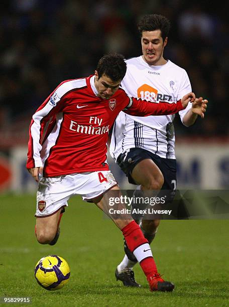 Cesc Fabregas of Arsenal competes with Tamir Cohen of Bolton Wanderers during the Barclays Premier League match between Bolton Wanderers and Arsenal...