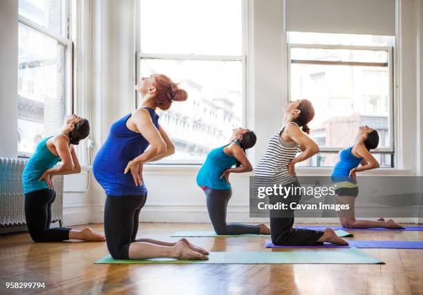 pregnant women practicing yoga in gym - prenatal yoga stock pictures, royalty-free photos & images