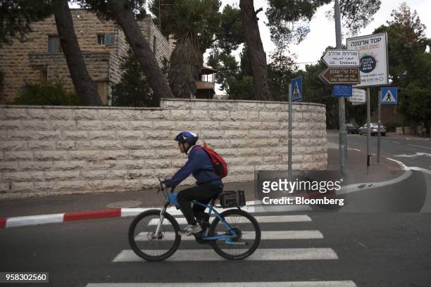 Cyclist rides rides past a new sign directing motorists toward the new U.S. Embassy in Jerusalem, Israel, on Sunday, May 13, 2018. One of...