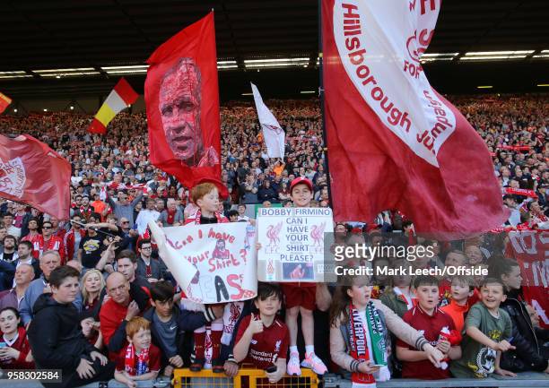 Fans waving flags on the Spion Kop during the Premier League match between Liverpool and Brighton and Hove Albion at Anfield on May 13, 2018 in...