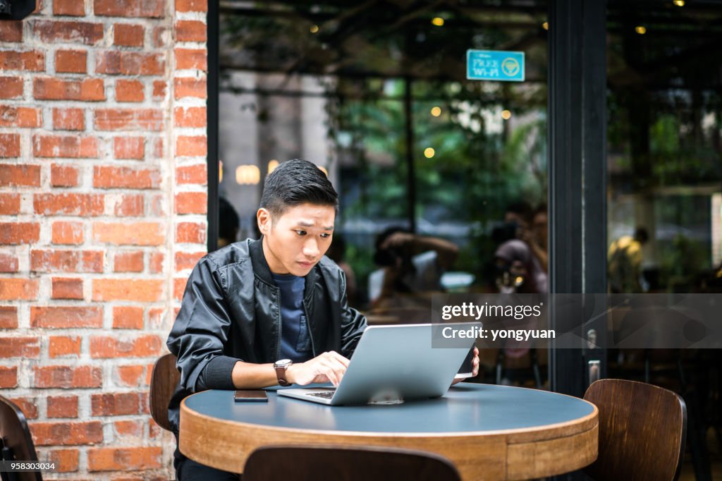 Young man feeling confused with his laptop