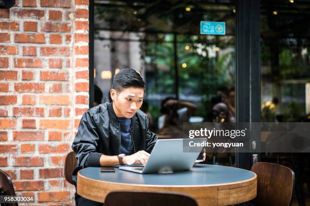 young man feeling confused with his laptop - yongyuan stock pictures, royalty-free photos & images