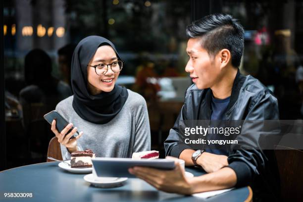 multi-ethnic couple having a talk - yongyuan stock pictures, royalty-free photos & images