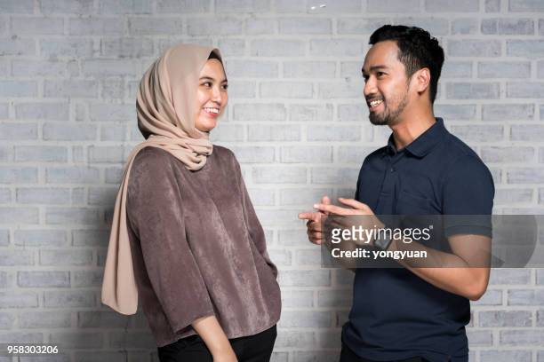 malaysian man and woman meeting and greeting - yongyuan stock pictures, royalty-free photos & images