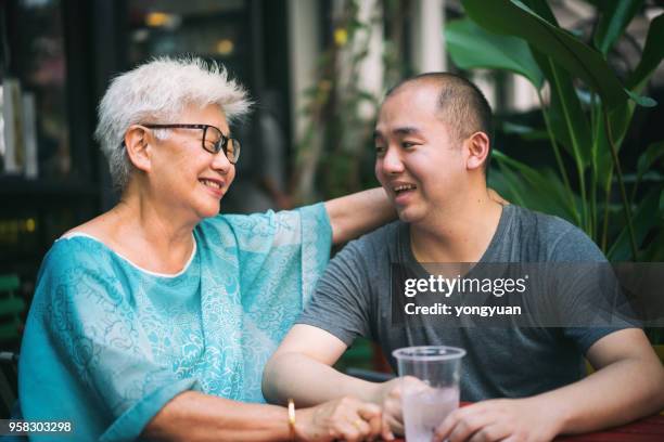 senior asian woman talking with her grandson - yongyuan stock pictures, royalty-free photos & images