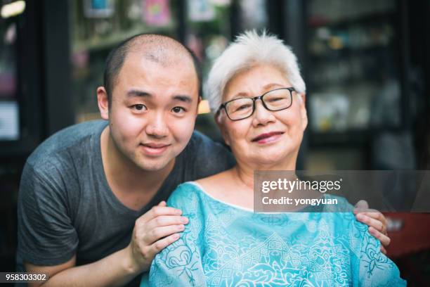 senior asian woman and her grandson - yongyuan stock pictures, royalty-free photos & images