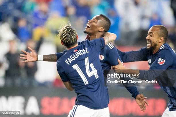 May 12: Cristian Penilla of New England Revolution is congratulated by team mates Diego Fagundez of New England Revolution and Teal Bunbury of New...