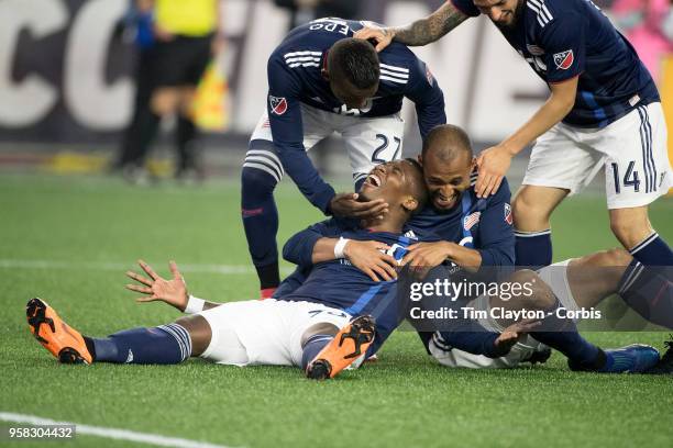 May 12: Cristian Penilla of New England Revolution is congratulated by team mates Teal Bunbury of New England Revolution, Luis Caicedol of New...