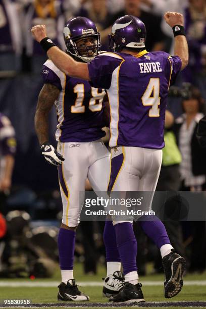 Quarterback Brett Favre of the Minnesota Vikings congratulates wide receiver Sidney Rice on his 45 yard touchdown against the Dallas Cowboys during...