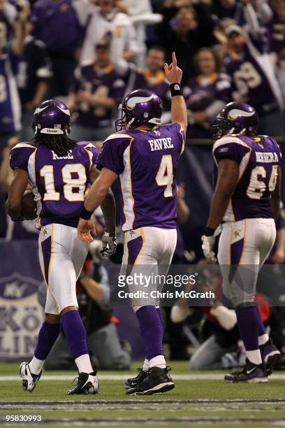 Wide receiver Sidney Rice, quarterback Brett Favre and offensive guard Anthony Herrera of the Minnesota Vikings celebrate Rice's 45 yard touchdown...