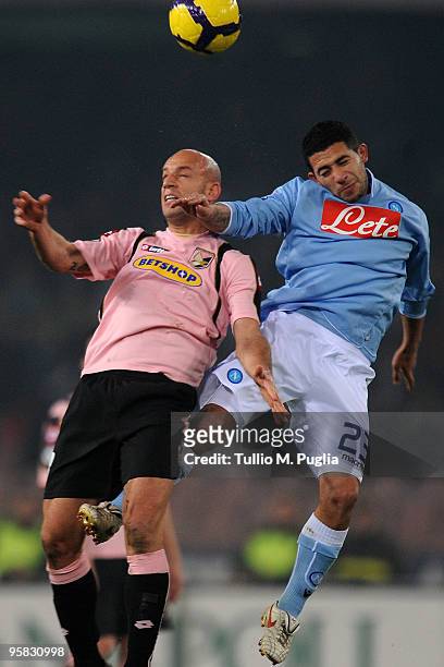 Giulio Migliaccio of Palermo and Walter Gargano of Napoli compete for a header during the Serie A match between SSC Napoli and US Citta di Palermo at...
