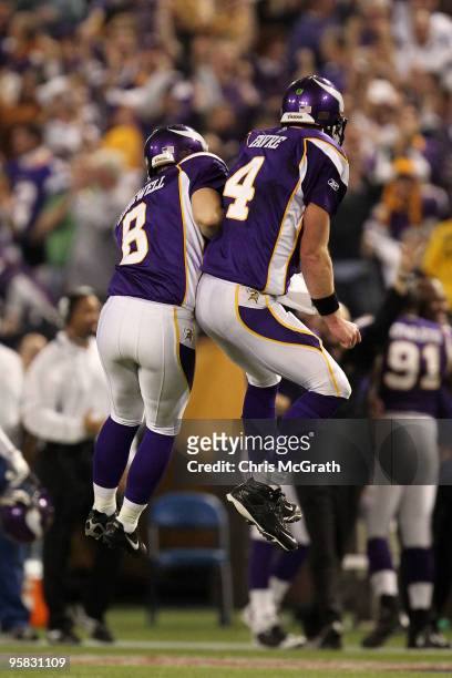 Quarterback Brett Favre of the Minnesota Vikings celebrates a touchdown with kicker Ryan Longwell during the game against the Dallas Cowboys during...