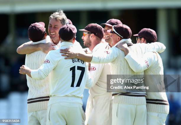 Surrey celebrate victory during day four of the Specsavers County Championship Division One match between Surrey and Yorkshire at The Kia Oval on May...