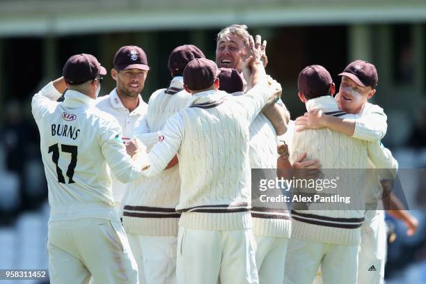 Surrey celebrate victory during day four of the Specsavers County Championship Division One match between Surrey and Yorkshire at The Kia Oval on May...
