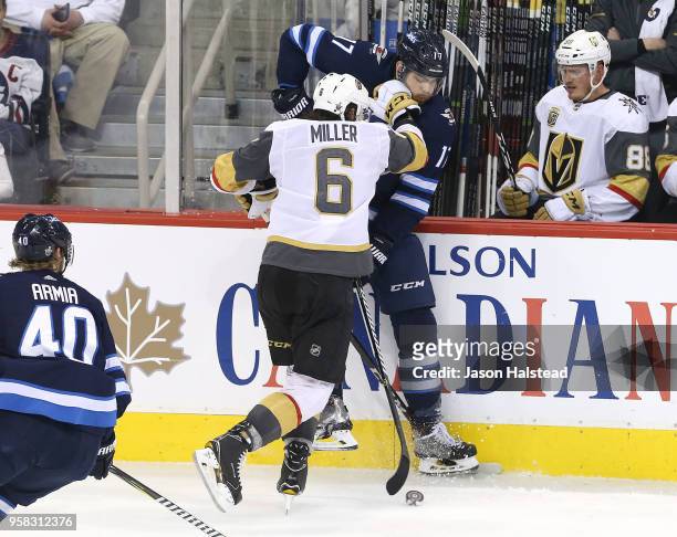 Colin Miller of the Vegas Golden Knights hits Adam Lowry of the Winnipeg Jets in Game One of the Western Conference Finals during the 2018 NHL...