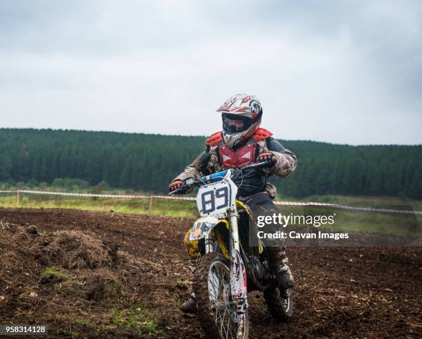 Motocross Riding A Rut 21 Young Male Motocross Racer Riding Across Field Stock Photos, High ...