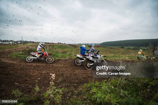 men riding dirt bikes on field during competition - the moto x film experience stock-fotos und bilder