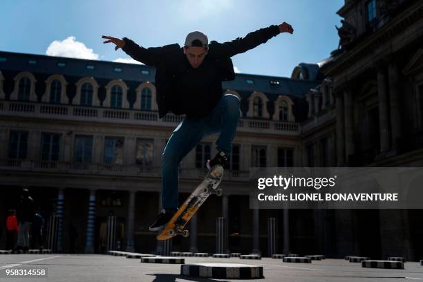 In this photograph taken on May 3 French skateboarder Joseph Garbaccio rides during a photo session at The Colonnes de Buren by French artist Daniel...