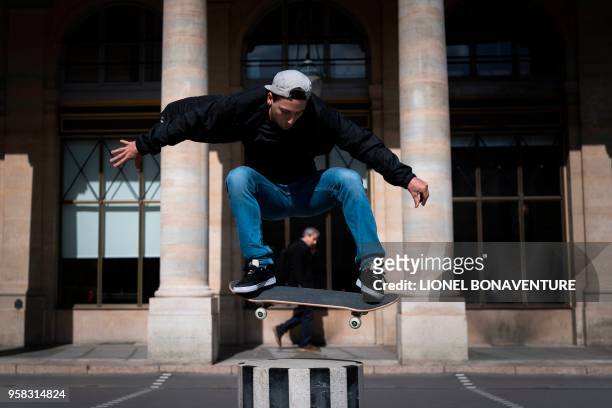 In this photograph taken on May 3 French skateboarder Joseph Garbaccio rides during a photo session at The Colonnes de Buren by French artist Daniel...