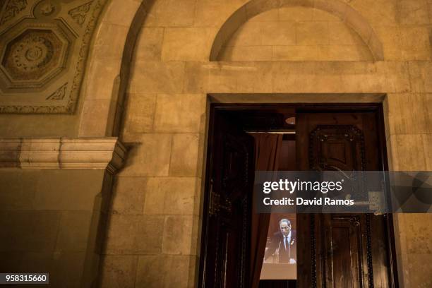 Quim Torra is displayed on a screen as he gives a speech during the second day of the parliamentary session debating on his investiture as the new...