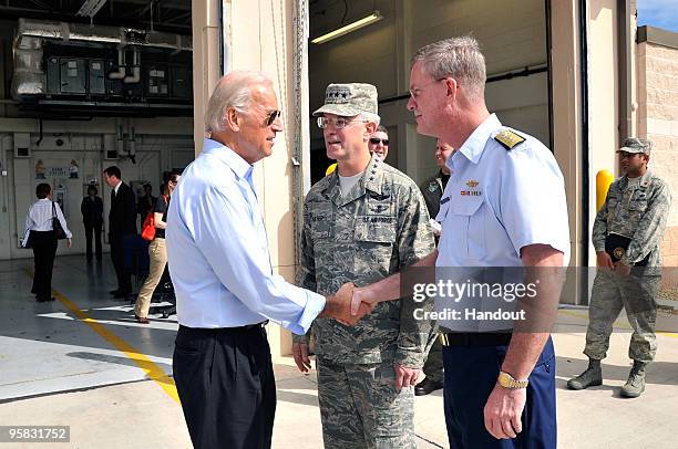 In this handout image provided by the U.S. Coast Guard, Vice President Joe Biden shakes hands with with Rear Adm. Steve Branham, commander of the...