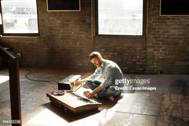 man playing piano while tuning audio equipment at home - pianist front fotografías e imágenes de stock