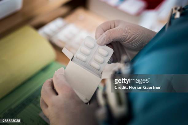 Nurse removes medication from a box on April 27, 2018 in Berlin, Germany.