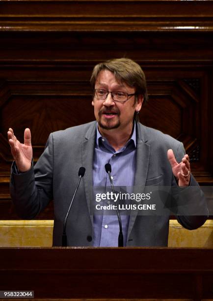 "Catalunya en comu podem" MP Xavier Domenech speaks during a vote session to elect a new regional president at the Catalan parliament in Barcelona on...