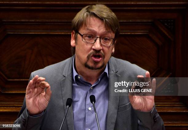 "Catalunya en comu podem" MP Xavier Domenech speaks during a vote session to elect a new regional president at the Catalan parliament in Barcelona on...