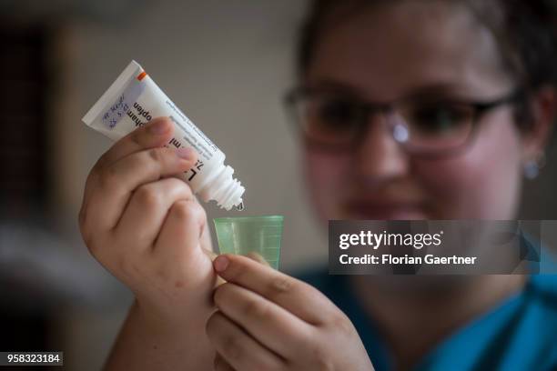 Nurse in a nursing home measures a medicine for a patient on April 27, 2018 in Berlin, Germany.