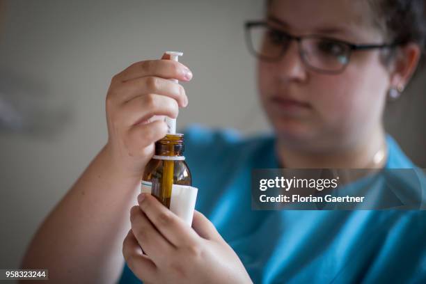 Nurse at a nursing home fills up a syringe on April 27, 2018 in Berlin, Germany.