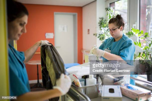 Two nurses of a nursing home work on a laundry cart on April 27, 2018 in Berlin, Germany.