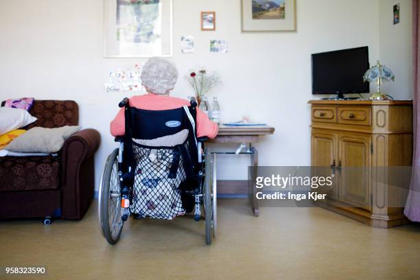 An elderly woman in a wheelchair sits alone in her room in a nursing home on April 27, 2018 in Berlin, Germany.
